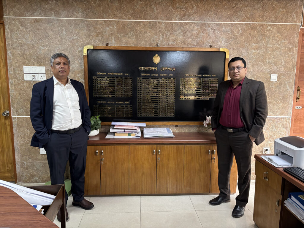 Two men standing in an office.