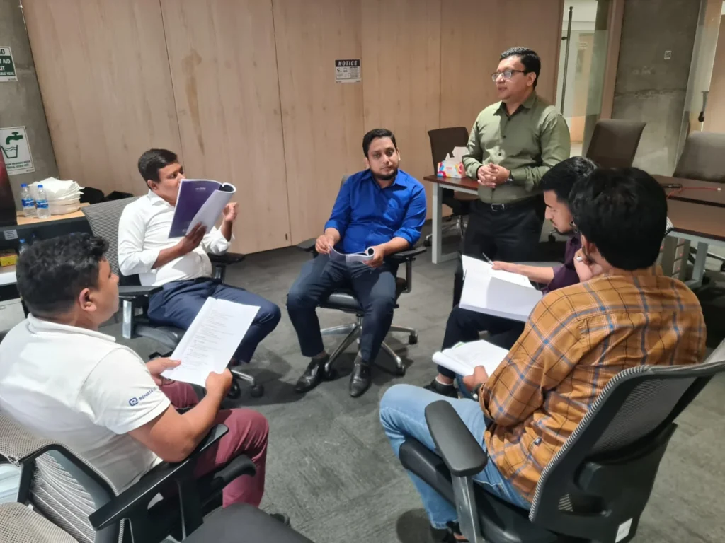 Participants engaged in group discussion during sales leadership workshop