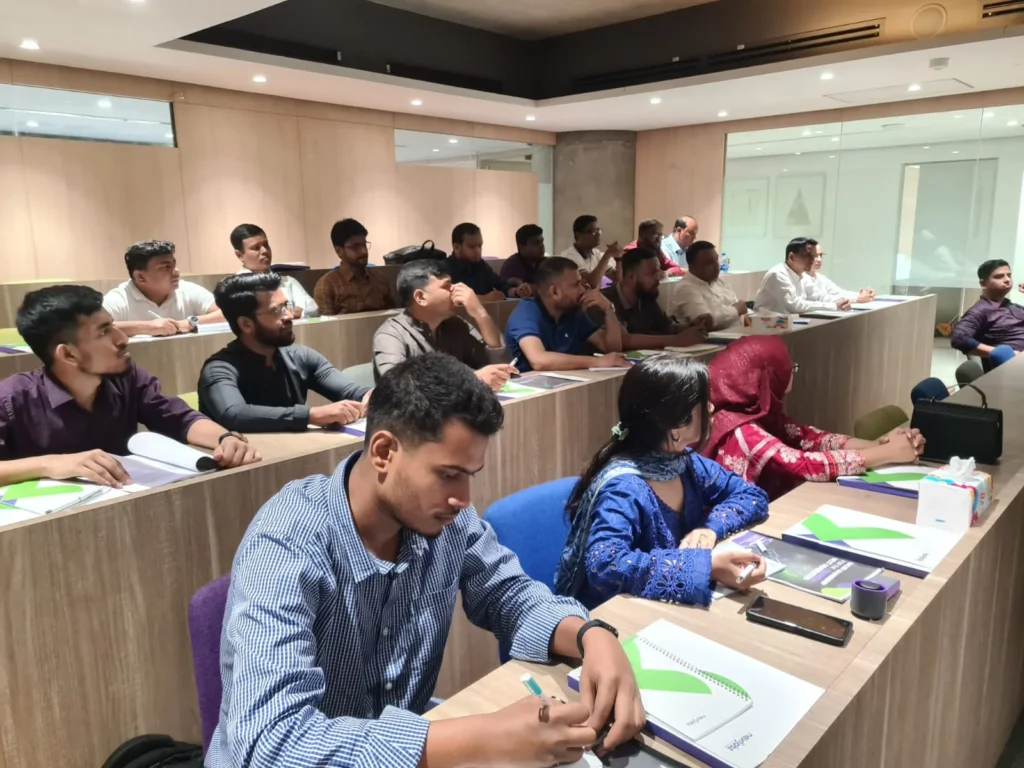 Participants working on leadership exercises during sales leadership workshop